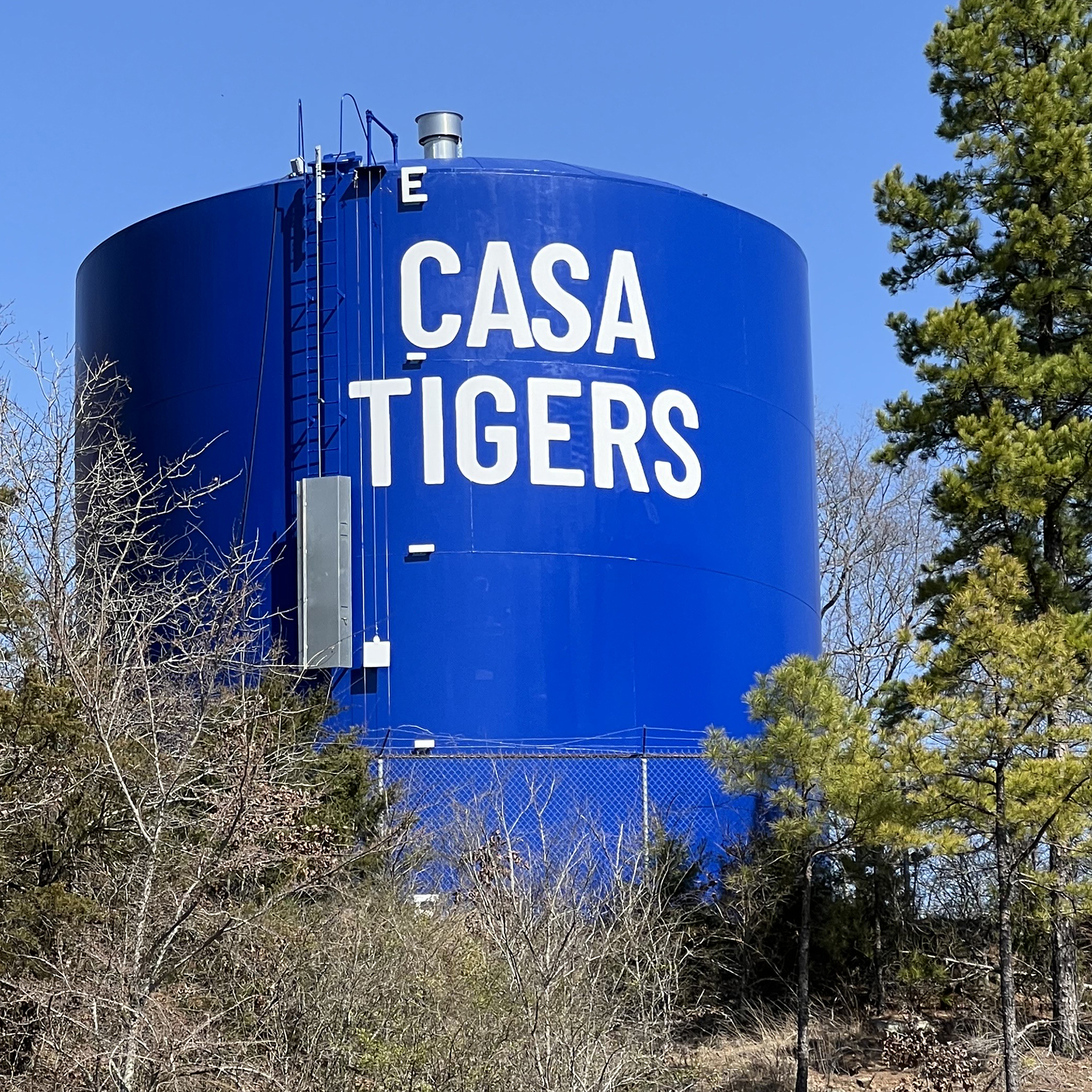 A bright blue water tower with the words Casa Tigers in white all-caps text.